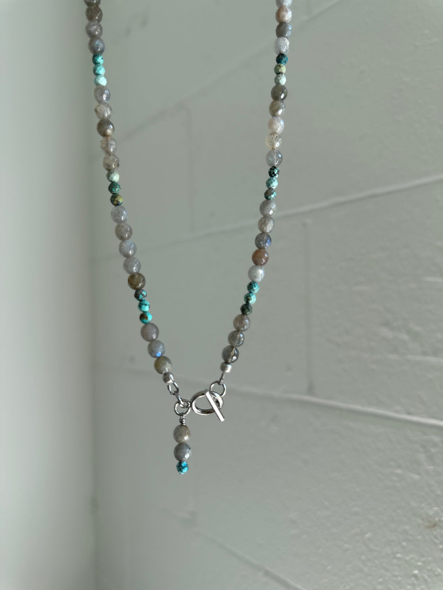 Necklace with small beads on a plain background
